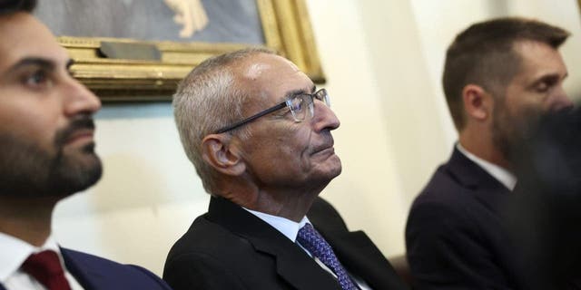 John Podesta listens as President Biden delivers remarks during a meeting at the White House on Sept. 6.