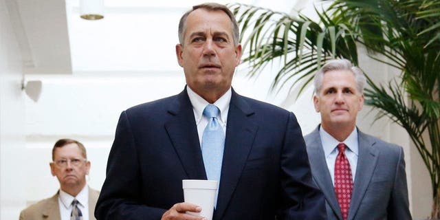 U.S. House Speaker John Boehner (R-OH) (C) and House Majority Whip Rep. Kevin McCarthy (R-CA) (R) arrive for a Republican caucus meeting at the U.S. Capitol in Washington, Oct. 15, 2013.