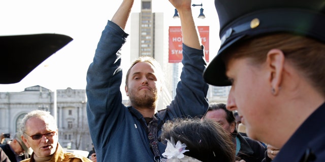 David DePape, accused of beating Paul Pelosi with a hammer records Gypsy Taub being led away by police after her nude wedding outside City Hall on Dec. 19, 2013, in this file photo.  