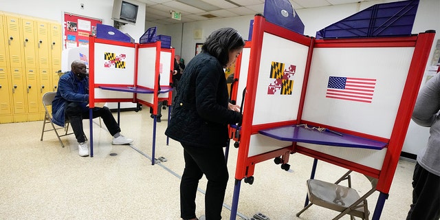 FILE - People fill out ballots during early voting at Westside Skill Center, Oct. 31, 2022, in Baltimore, Maryland. Midterm elections are being held on Tuesday, Nov. 8. 