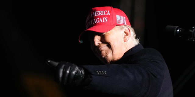 Former President Donald Trump reacts to a supporter during a rally, Thursday, Nov. 3, 2022, in Sioux City, Iowa. 