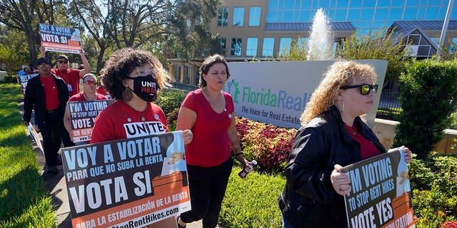 Orange County rent control advocates demonstrate in front of the Florida Realtors office building on Oct. 22, 2022, in Orlando, Florida.