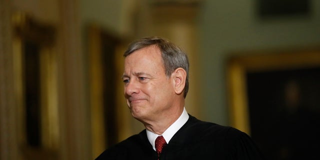 In this Jan. 16, 2020, file photo Chief Justice of the United States, John Roberts walks to the Senate chamber at the Capitol in Washington. Roberts praised state and federal courts in his year-end report. (AP Photo/Matt Rourke, File)