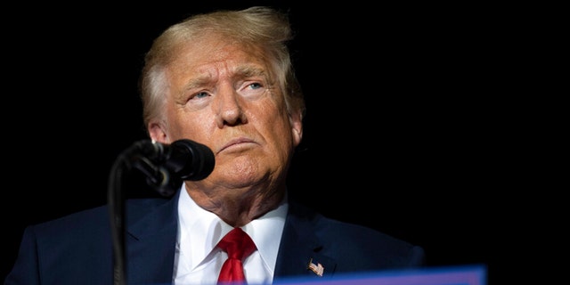 Former President Donald Trump pauses while speaking at a rally at the Minden Tahoe Airport in Minden, Nev., on Oct. 8, 2022. 