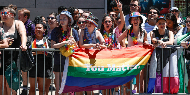 People hold a rainbow flag during the 51st LGBTQ Pride Parade in Chicago June 26, 2022.