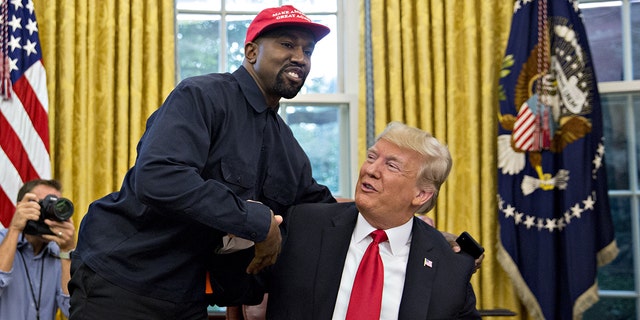 Rapper Kanye West, left, shakes hands with U.S. President Donald Trump during a meeting in the Oval Office of the White House in Washington, D.C., U.S., on Thursday, Oct. 11, 2018. 