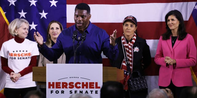 Georgia Republican Senate candidate Herschel Walker speaks as (L-R) Republican National Committeewoman for Georgia Ginger Howard, RNC Chair Ronna McDaniel, Walker’s wife Julie Blanchard and former South Carolina governor and former Ambassador to the U.N. Nikki Haley listen during a campaign rally Dec. 5, 2022, in Kennesaw, Ga.