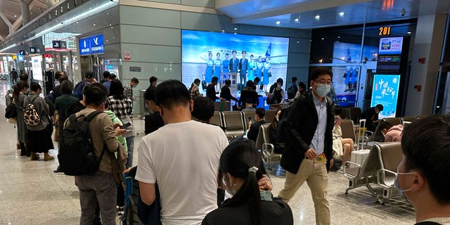 Passengers prepare to board a flight at the airport in north-central China's Jiangxi province on Nov. 1, 2022. 