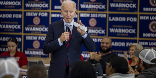 President Joe Biden speaks to volunteers at a phone banking event on Dec. 2, 2022, in Boston, Massachusetts, for the re-election campaign of Democratic Sen. Raphael Warnock of Georgia.