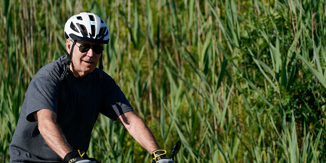 President Joe Biden rides a bike in Rehoboth Beach, Delaware, June 18, 2022.