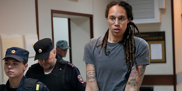 WNBA star and two-time Olympic gold medalist Brittney Griner is escorted from a courtroom after a hearing in Khimki, just outside Moscow, Russia, on Aug. 4, 2022.