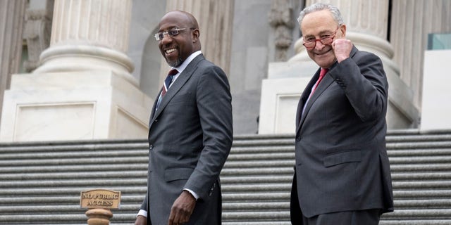 Senate Majority Leader Chuck Schumer, D-N.Y., and Sen. Raphael Warnock, D-Ga., walk up the Senate steps as Warnock returns to Washington after winning the Georgia runoff election Dec. 7, 2022, in Washington, D.C.