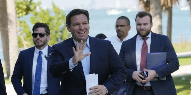 Florida Gov. Ron DeSantis waves as he arrives for a news conference at Bill Baggs Cape Florida State Park, Thursday, Dec. 1, 2022, on Key Biscayne, Fla. 