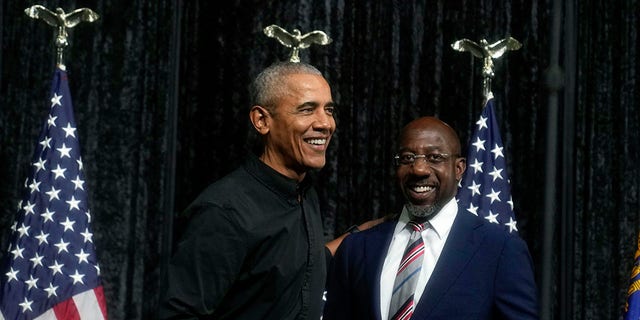 Former President Barack Obama, left, greets Sen. Raphael Warnock, D-Ga., right, before Obama speaks during a rally on Thursday, Dec. 1, 2022, in Atlanta. 