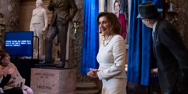 Speaker of the House Nancy Pelosi, D-Calif., is joined by her husband Paul Pelosi as they attend her portrait unveiling ceremony in Statuary Hall at the Capitol in Washington, Wednesday, Dec. 14, 2022. 