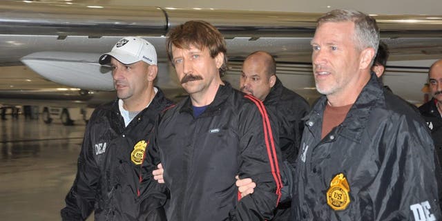 WHITE PLAINS, NY - NOVEMBER 16:  In this photo provided by the U.S. Department of Justice, former Soviet military officer and arms trafficking suspect Viktor Bout (C) deplanes after arriving at Westchester County Airport November 16, 2010 in White Plains, New York. Bout was extradited from Thailand to the U.S. to face terrorism charges after a final effort by Russian diplomats to have him released failed. (Photo by U.S. Department of Justice via Getty Images)