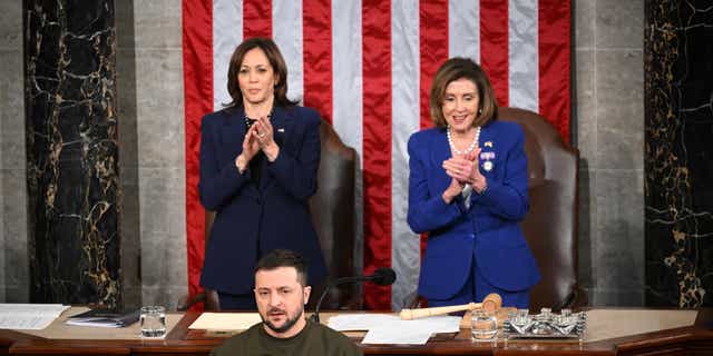 Ukraine's President Volodymyr Zelenskyy addresses the US Congress as U.S. Vice President Kamala Harris and US House Speaker Nancy Pelosi applaud at the US Capitol in Washington, D.C. on December 21, 2022. 