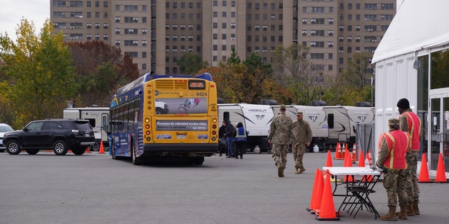 Migrants board MTA busses to be transported to a Hotel after NYC Mayor Adams announced the temporary housing unit would be closed indefinitely, Nov. 15, 2022.