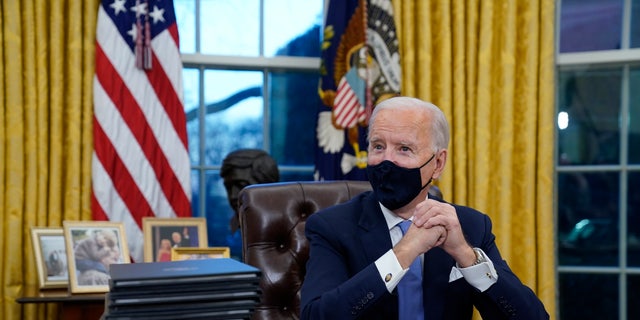 President Joe Biden signs his first executive orders, including one canceling the Keystone XL pipeline's federal permits, in the White House on Jan. 20, 2021.