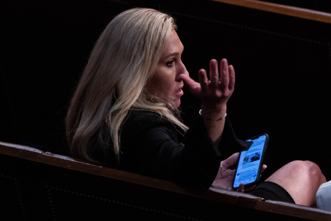 Rep.-elect Marjorie Taylor Greene of Georgia gestures to a colleague on the House floor, following another round of voting for a new House speaker on the first day of the 118th Congress, Tuesday, January 3, 2023. 