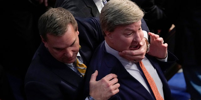 Rep. Richard Hudson, R-N.C., left, pulls Rep. Mike Rogers, R-Ala., back as they talk with Rep. Matt Gaetz, R-Fla., and other during the 14th round of voting for speaker as the House meets for the fourth day to try and elect a speaker and convene the 118th Congress in Washington, Friday, Jan. 6, 2023. 