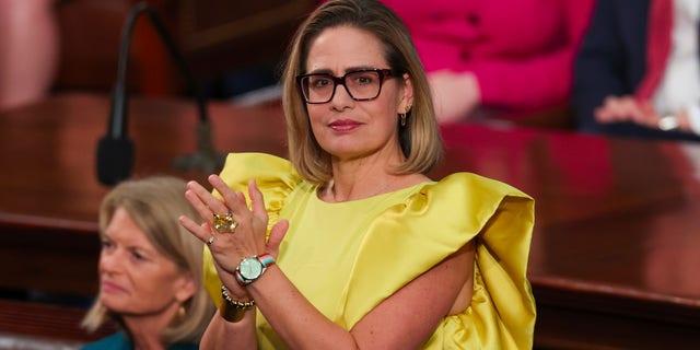 Sen. Kyrsten Sinema applauds during President Biden's State of the Union address at the U.S. Capitol on Feb. 7, 2023.