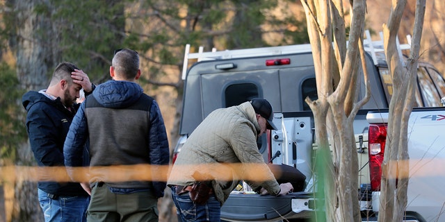 Law enforcement personnel investigate the scene of multiple shootings on Arkabutla Dam Road in Arkabutla, Mississippi on Friday, Feb. 17, 2023. 