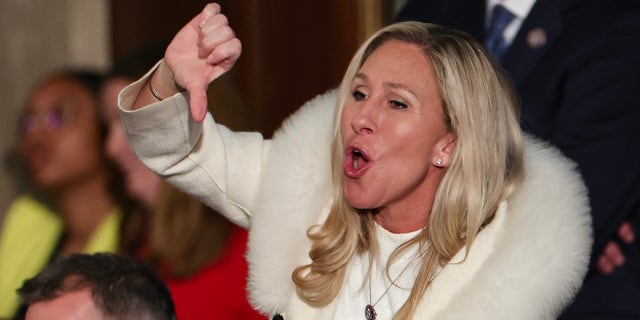 Rep. Marjorie Taylor Greene, R-Ga., gives a thumbs down during President Joe Biden's State of the Union address during a joint meeting of Congress in the House Chamber of the U.S. Capitol on February 07, 2023 in Washington, DC. 