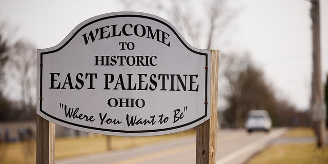 A sign welcomes visitors to the town of East Palestine on February 14, 2023 in East Palestine, Ohio. A train operated by Norfolk Southern derailed on February 3, releasing toxic fumes and forcing evacuation of residents. 