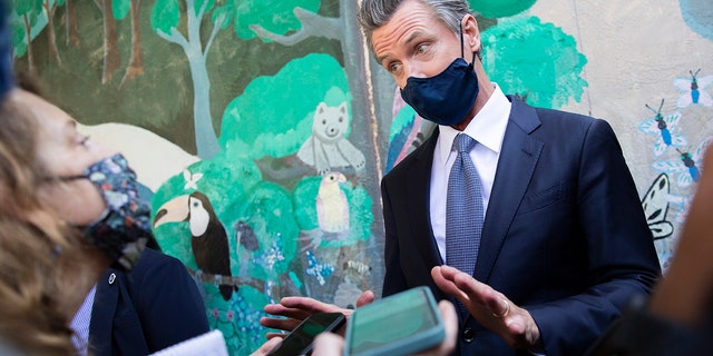 California Gov. Gavin Newsom speaks with reporters at Carl B. Munck Elementary School, Wednesday, Aug. 11, 2021, in Oakland, Calif. 