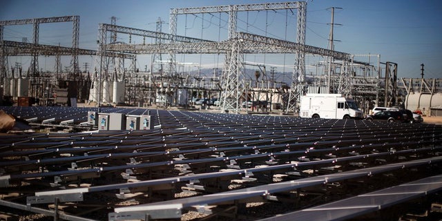 Solar panels are seen next to a Southern California Edison electricity station in Carson, California, on March 4, 2022.