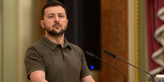 Ukrainian President Volodymyr Zelenskyy stands at the podium during a joint news conference with Australian Prime Minister Anthony Albanese, in Kyiv, Ukraine, July 3, 2022. 