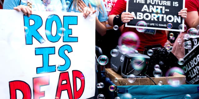 Anit-abortion activists hold signs outside the US Supreme Court after overturning of Roe Vs. Wade, in Washington, DC, on June 24, 2022.