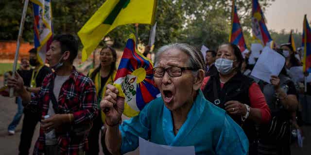 Exile Tibetan activists hold blank white papers symbolizing government censorship in China, while shouting anti-China slogans during a protest in New Delhi, India, Friday, Dec. 2, 2022.