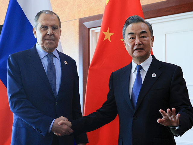 In this photo released by the Russian Foreign Ministry Press Service, Russian Foreign Minister Sergey Lavrov, left, and Chinese Foreign Minister Wang Yi pose for a photo prior to their talks on the sideline of the 12th East Asia Summit foreign ministers' meeting in Phnom Penh, Cambodia, on Aug. 5, 2022. Wang defended his country's position on the war in Ukraine on Sunday, Dec. 25, and signaled that China would deepen ties with Russia in the coming year while striving to bring US China ties back on the right course. (Russian Foreign Ministry Press Service via AP, File)