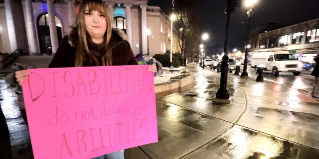 Laura Green with fellow demonstrators outside Framingham City Hall protesting comments from Michael Hugo.