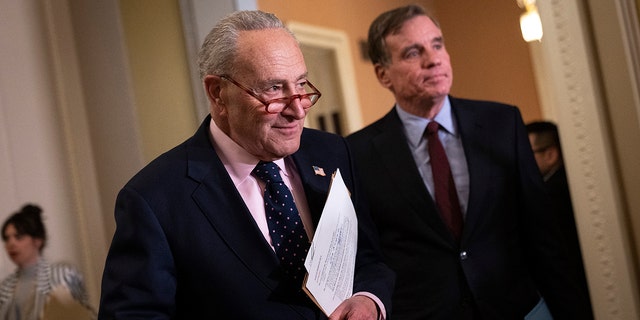 Senate Majority Leader Chuck Schumer, D-NY, and Sen. Mark Warner, D-VA, arrives for a news conference following a closed-door lunch meeting with Senate Democrats at the U.S. Capitol March 22, 2023, in Washington, DC. 