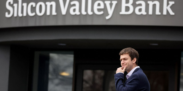 A customer stands outside a shuttered Silicon Valley Bank headquarters March 10, 2023, in Santa Clara, Calif.