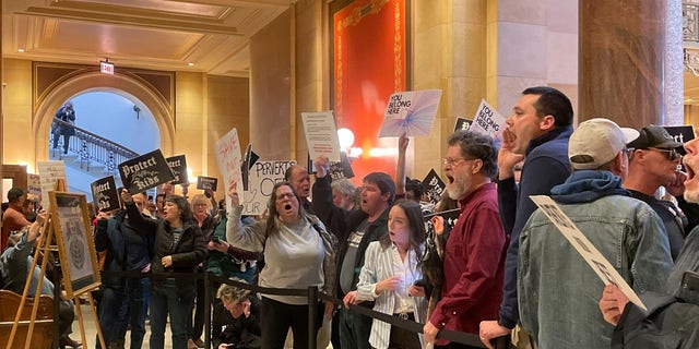 Dozens of protesters chanted for and against a bill that would make Minnesota a trans refuge state, which is a counter to states attempting to ban transgender care for minors, Thursday, March 23, 2023, in St. Paul, Minnesota.