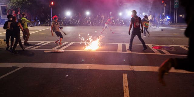 CMPD officers deploy a stun grenade during a demonstration for the end of police brutality in uptown Charlotte, North Carolina, on June 2, 2020.