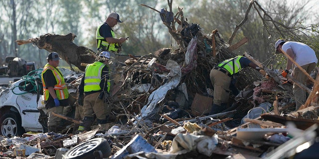 Emergency rescuers and first responders climb through a tornado demolished mobile home park looking for bodies that might be buried in the piles of debris, insulation, and home furnishings, Saturday morning, March 25, 2023, in Rolling Fork, Miss. Emergency officials in Mississippi say several people have been killed by tornadoes that tore through the state on Friday night, destroying buildings and knocking out power as severe weather produced hail the size of golf balls moved through several southern states.