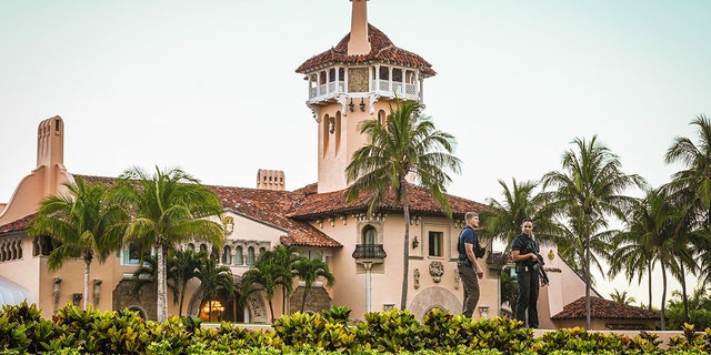 Secret Service agents stand guard outside the Mar-a-Lago home of former President Donald Trump on March 27, 2023, in Palm Beach, Florida.