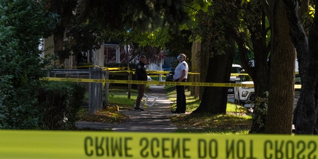 Police officers investigate a crime scene after a shooting at a backyard party on Sept. 19, 2020, in Rochester, New York.