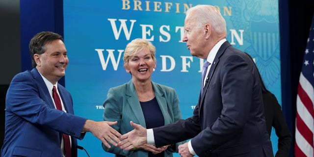 President Biden shakes hands with former White House Chief of Staff Ron Klain as Energy Secretary Jennifer Granholm looks on at the White House on June 30, 2021.