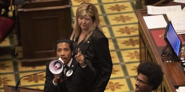 Tennessee state Rep. Justin Jones calls on his colleagues to pass gun control legislation at the State Capitol, March 30, 2023, in Nashville.