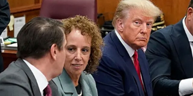 Former President Donald Trump sits with his defense team in a Manhattan court during his arraignment on April 4, 2023, in New York City.