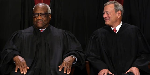 United States Supreme Court Associate Justice Clarence Thomas (L) and Chief Justice of the United States John Roberts (R)