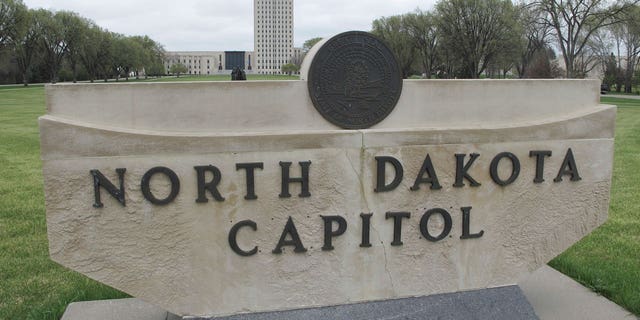 The North Dakota Capitol tower rises in the background behind a stone sign, April 19, 2012, in Bismarck, North Dakota. The North Dakota House of Representatives has passed a bill that would ban virtually all abortions after six weeks of pregnancy.