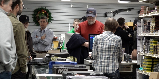 Customers wait in line at Northwest Armory Dec. 6, 2022, in Milwaukie, Ore.