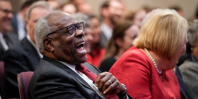 Supreme Court Justice Clarence Thomas sits with his wife and conservative activist Virginia Thomas.